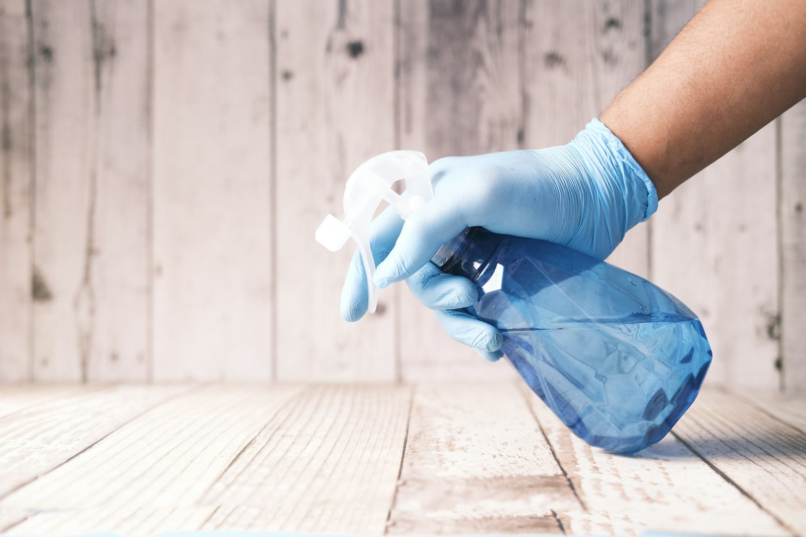 Happy diverse professional cleaners standing with arms crossed and looking at camera.